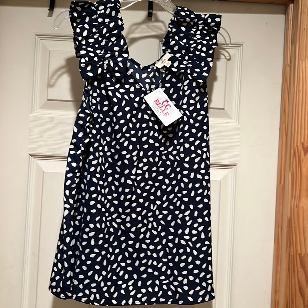 Super cute blue with white polka dots and RUFFLES on the sleeves.